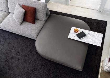 The leather pouf in the Dee Dee corner sofa can also become the end element of the composition - BertO