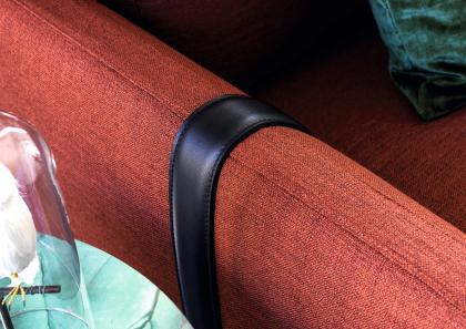 An exclusive leather strap wraps the arm of the sofa with a reversible Dee Dee peninsula - BertO